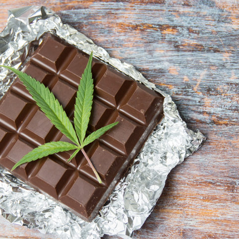Marijuana leaves on top of dark chocolate